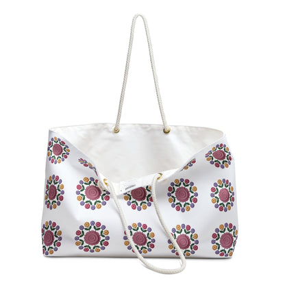 Crochet Floral Weekender Bag: A close-up of a stylish crochet floral pattern on a cream-colored background, highlighting its spacious design and comfortable cotton rope handles, perfect for weekend getaways.