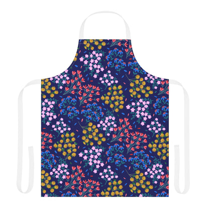 Floral Apron features a vibrant floral pattern with clusters of colorful blossoms on a dark background, complemented by white neck and waist ties, embodying FireBrook Designs' blend of style and comfort.