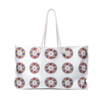 Crochet Floral Weekender Bag with detailed crochet floral pattern and cream background. Spacious, stylish bag for weekend getaways, featuring comfortable cotton rope handles and luxurious cream sheeting interior lining.