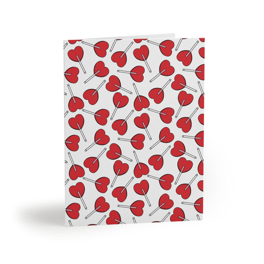 Love Greeting Cards — Pack of 8/16/24 featuring a delightful edge-to-edge pattern of red heart-shaped lollipops on a white background. Matte-finish, folded, with a matching white envelope.