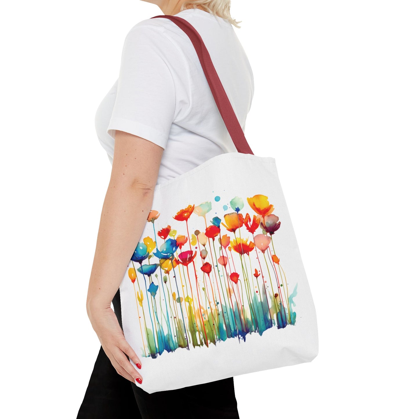 Watercolor Floral Tote Bag featuring a vibrant floral design, held by a woman. Ideal for style and functionality in daily errands. Available in multiple sizes.