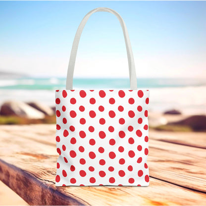Red Polka Dots Tote Bag with a playful design sits on a wooden table, perfect for errands or beach outings. A durable, stylish accessory from FireBrook Designs, enhancing daily life with joy.