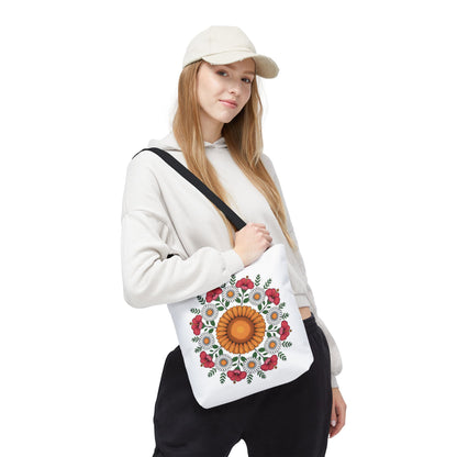 Mandala Sunflowers & Daisies Tote Bag: Young woman models a white canvas tote adorned with a sunflower-centered mandala, encircled by daisies and poppy-like flowers, showcasing a boho-chic style.