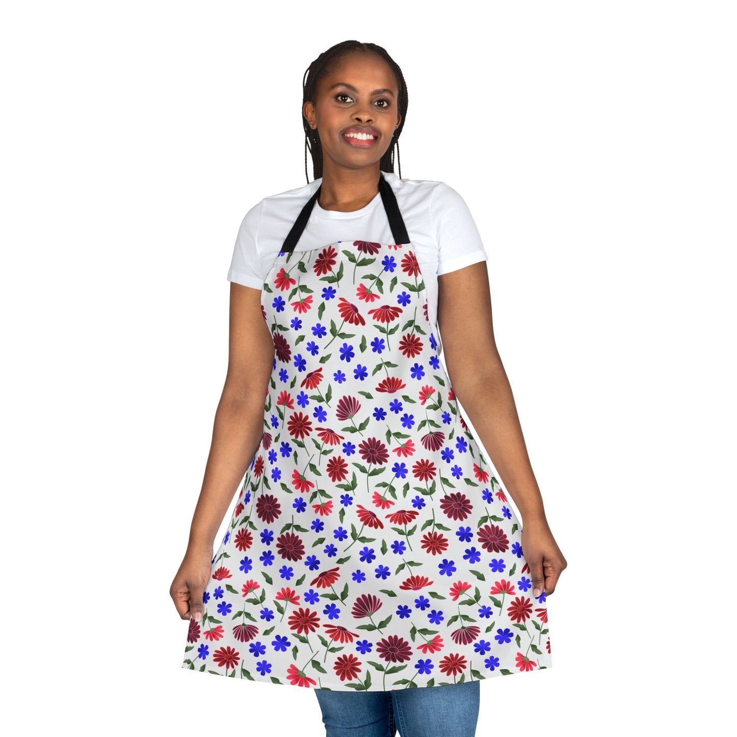 Floral Apron: A young woman smiles while modeling a comfortable, stain-free apron featuring vibrant red and burgundy daisies, ideal for kitchen tasks, from FireBrook Essentials' uplifting and stylish collection.
