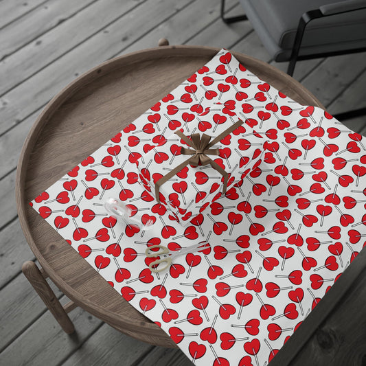 Cherry Pattern Wrapping Paper Roll – Red Heart Cherries Gift Wrap for Valentine’s Day displayed on a wooden table, ready for gift-wrapping with scissors, tape, and a wrapped box tied with a brown ribbon.