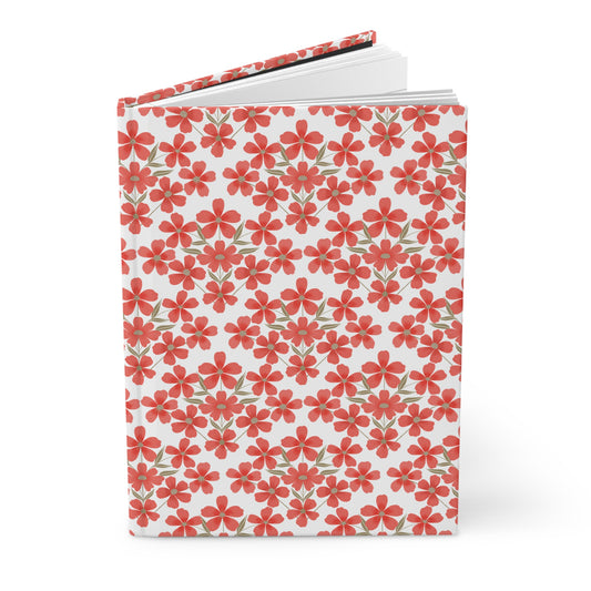 HARDCOVER JOURNAL, MATTE, RULED, 5X7, SEWN BIND, CLEAN-TEAR PAGES - FLORAL GRID, featuring a vivid floral pattern of red flowers and green leaves on a durable, matte-finished cover, slightly open to reveal lined pages.