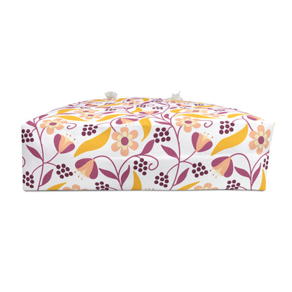 Weekender Bag with a spacious design features a floral-and-vine patterned fabric, showcasing stylized flowers and leaves in pink, peach, and mustard hues, complemented by practical rope handles for easy carrying.