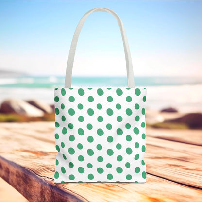 Green Polka Dots Tote Bag on a wooden table, featuring a cheerful green and white polka dot design, ideal for brightening everyday outings with its playful style and practical, durable construction.