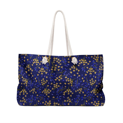 Weekender Bag with thick white rope handles and a deep navy blue body, featuring a delicate botanical pattern. Perfect for stylish travel, aligning with FireBrook Essentials' uplifting, practical design ethos.