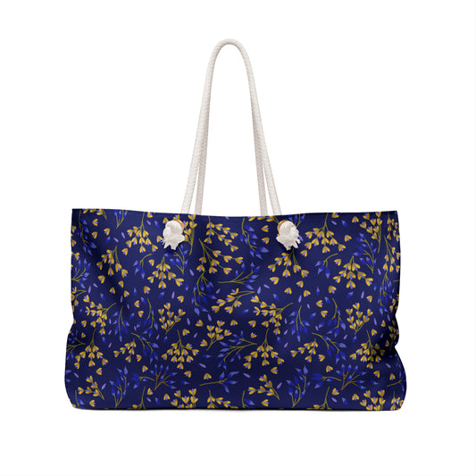 Weekender Bag with thick white rope handles and a deep navy blue body, featuring a delicate botanical pattern. Perfect for stylish travel, aligning with FireBrook Essentials' uplifting, practical design ethos.