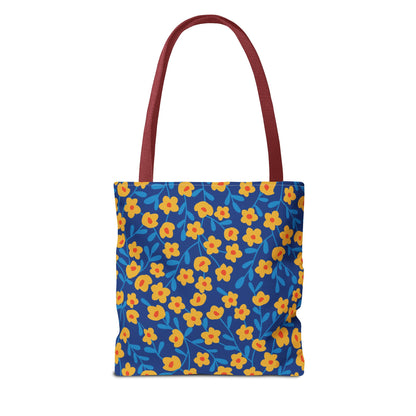 Cobalt Poppy Field Tote Bag with burgundy-red handles, featuring a bold floral pattern of yellow-orange blossoms and light-blue sprigs on a deep blue background, perfect for vibrant summer outings.