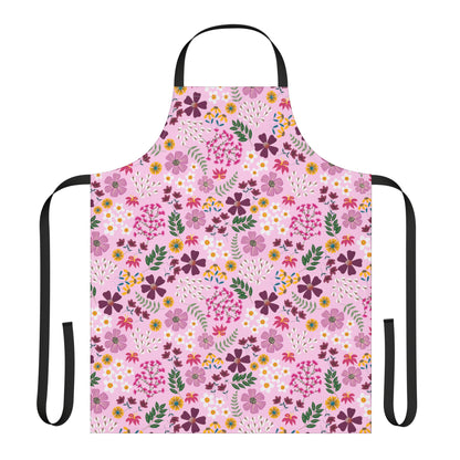 Floral Apron with vibrant, all-over floral print on a pale pink field; features black neck loop and waist ties, crafted from 100% polyester canvas for softness and stain-free convenience.