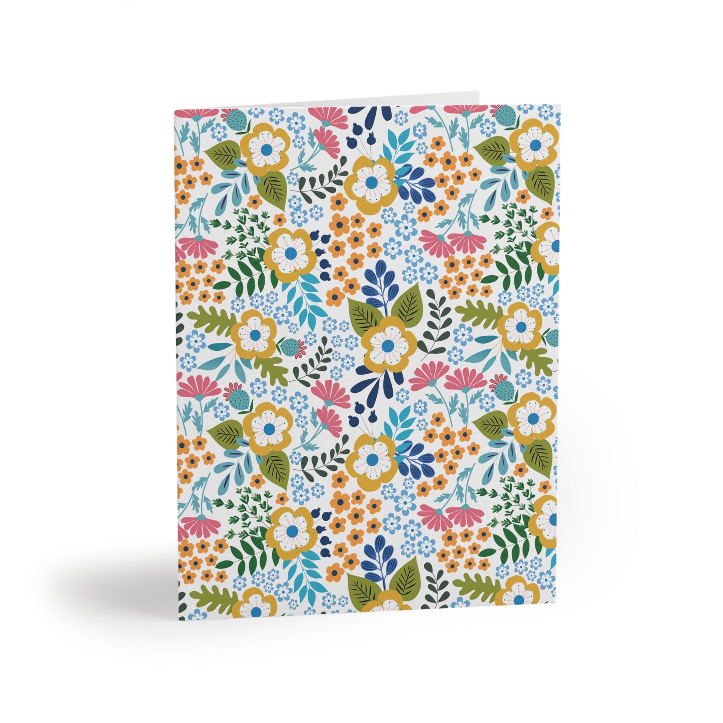 Wildflower Greeting Cards — Pack of 8/16/24, featuring vibrant, hand-drawn wildflowers with yellow-rimmed and pink daisy-like blooms amidst green foliage, set against a matte white background, embodying joyful, springtime energy.
