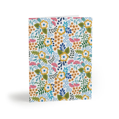 Wildflower Greeting Cards — Pack of 8/16/24 features a vibrant floral motif with stylized blooms and leaves, offering a cheerful, garden-inspired design on white card stock, perfect for uplifting messages.