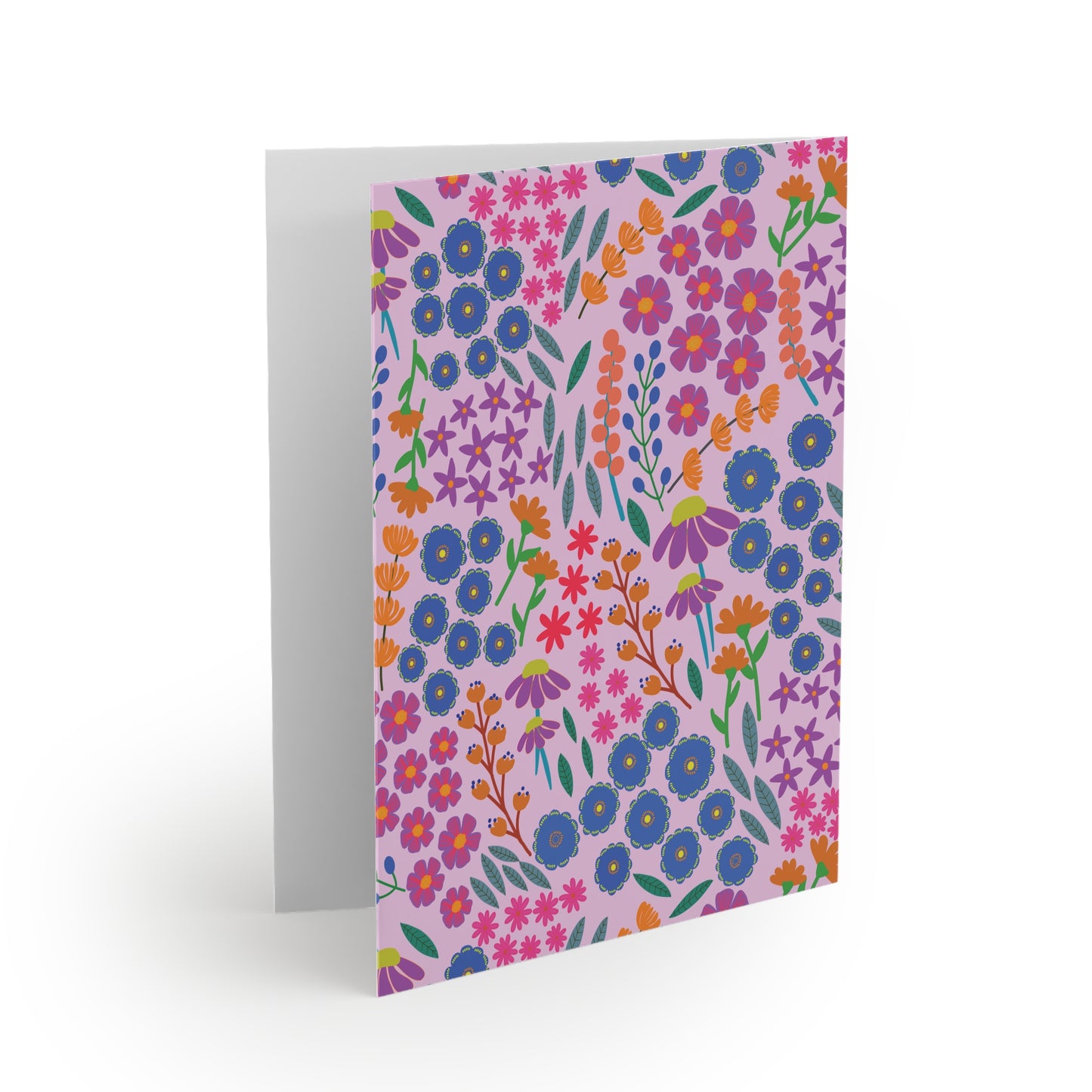 Floral Greeting Cards — Pack of 8/16/24: A folded card with vibrant floral patterns in blue, orange, pink, and green on a light pink background, showcasing the blank white interior for personalized messages.