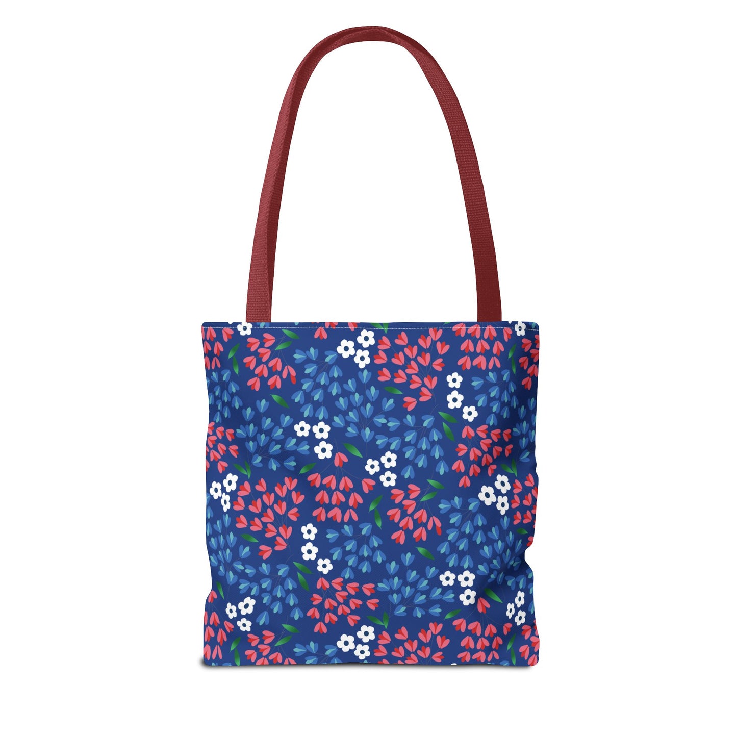 Berry Blue Festival Tote Bag features a deep blue body adorned with white blossoms and colorful leaf-shaped petals, complemented by burgundy-red straps. Ideal for summer outings, blending style and functionality.