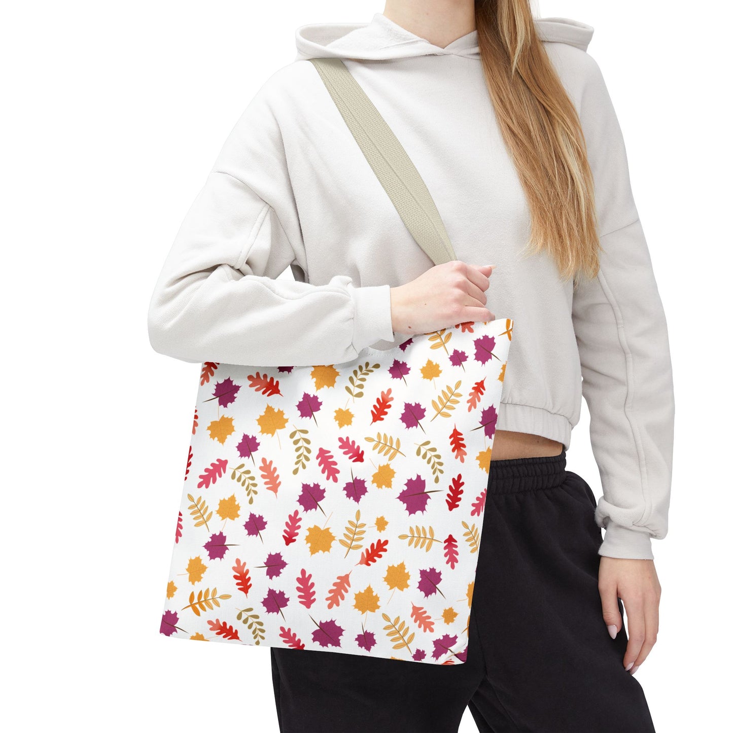 Autumn Leaves Tote Bag featuring a vibrant leaf pattern in autumn shades, carried by a person in casual attire. Ideal for daily use, it embodies FireBrook Designs' blend of style and practicality.