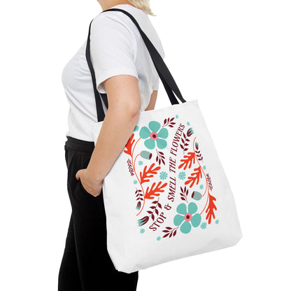 Stop and Smell The Flowers Tote Bag held by a woman, showcasing its nature-inspired design and functionality for carrying essentials.