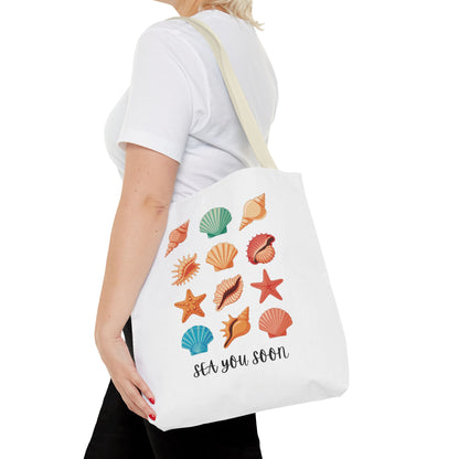 Sea You Soon Sea Shells Tote Bag featuring a beachy design with seashells, perfect for ocean lovers. Durable polyester with reinforced handles, ideal for beach trips and casual outings.