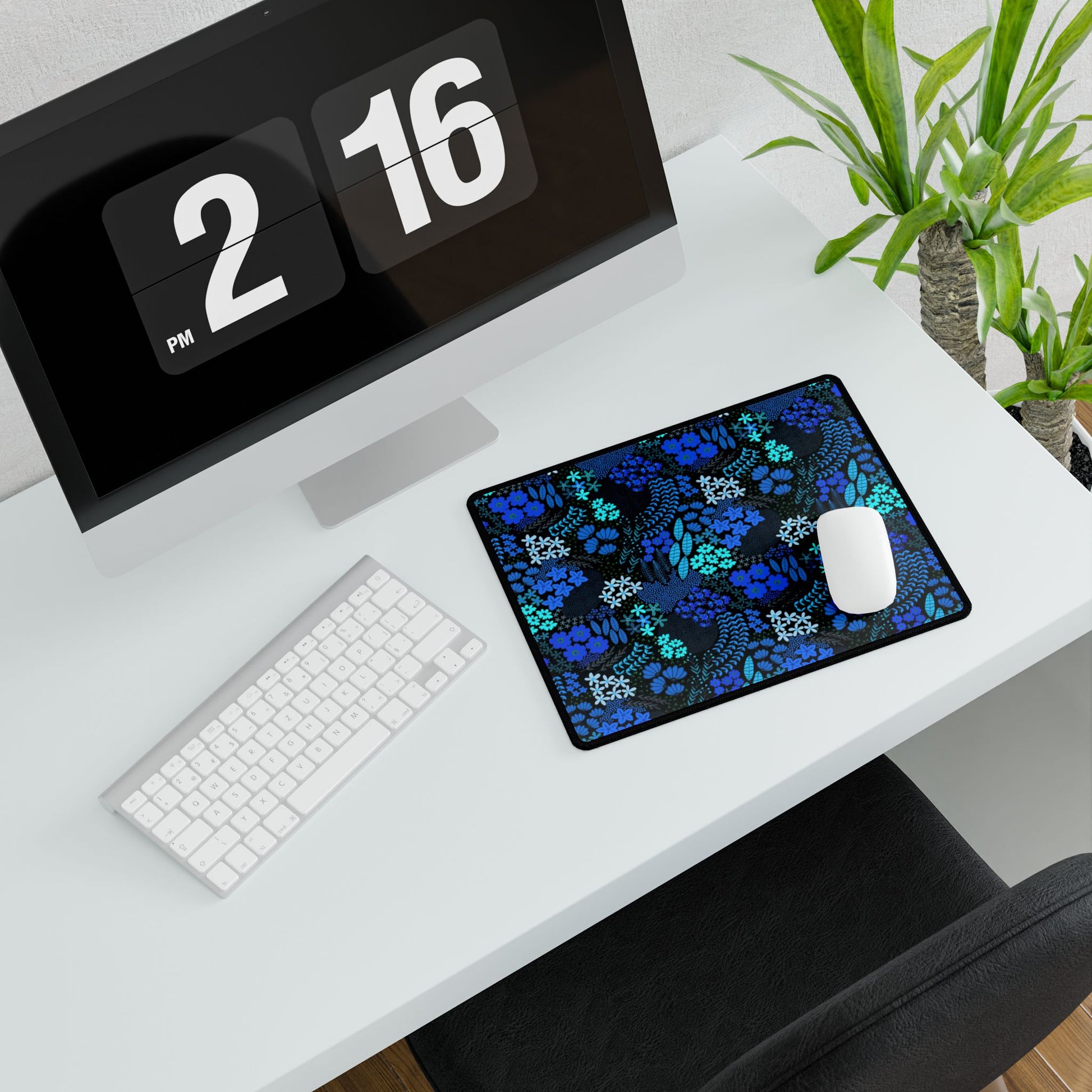 Blue Floral Desk Mat with dark blue and turquoise floral pattern beneath a white wireless mouse, enhancing the minimalist desk setup with a vibrant touch, perfect for elevating any workspace's aesthetic.