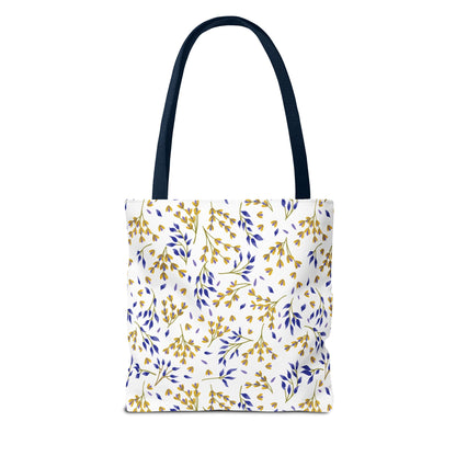 Floral Tote Bag with navy straps, showcasing a repeating gold and blue botanical motif on white. Designed for durability and style, perfect for summer outings or beach trips.