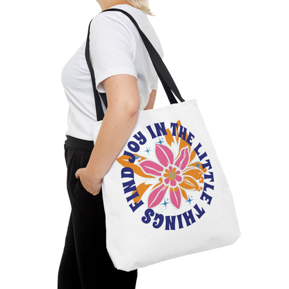 Find Joy in Little Things Tote Bag with a colorful flower design, held by a woman, showcasing its spacious, durable, and versatile features for everyday use.