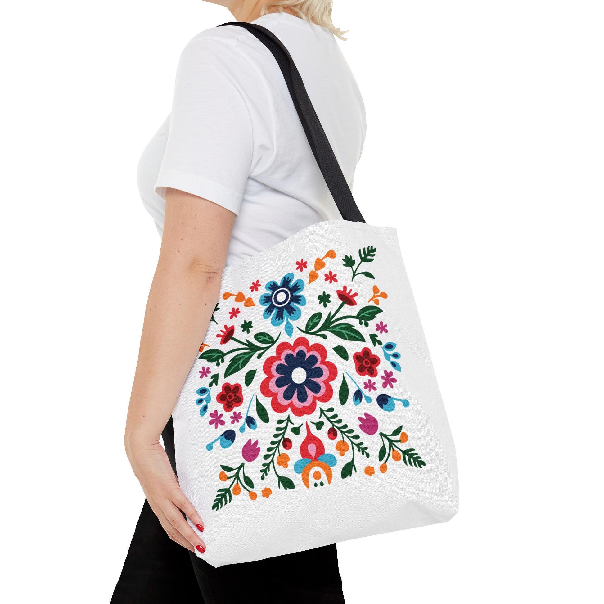 Woman holding Floral Tote Bag with colorful flower design, showcasing its durable polyester material and reinforced handles for stylish, practical use.
