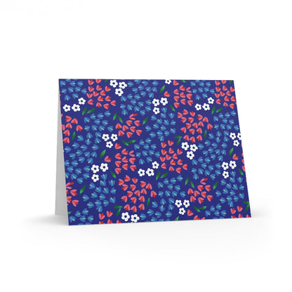 Floral Wildflower Greeting Cards — Pack of 8/16/24, featuring a vibrant repeating floral pattern on a deep blue background, propped open to show a blank interior, ready for personalization.