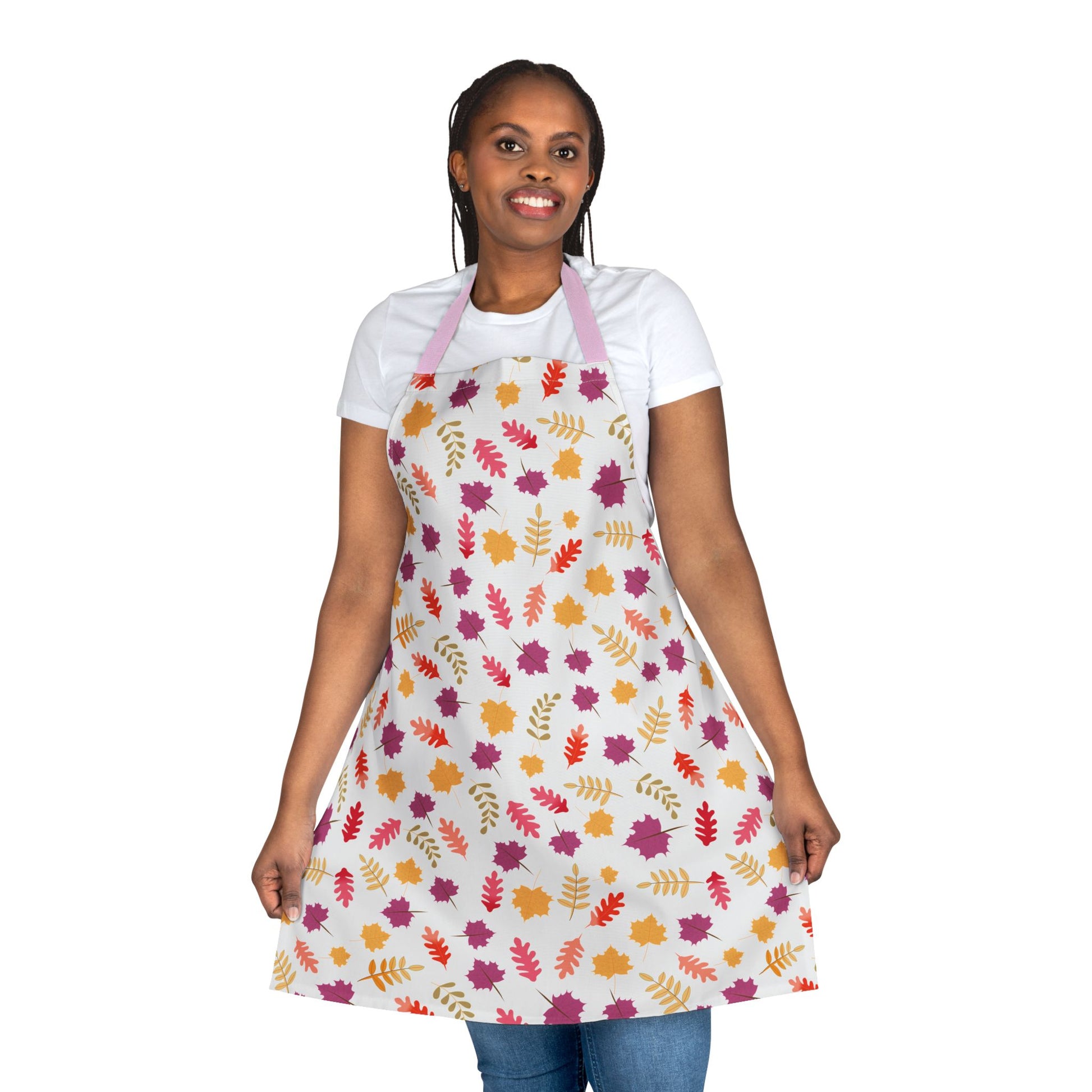 Person models the Apron Floral Design, featuring autumnal leaf patterns on a white background, showcasing its vibrant, stain-free polyester canvas that embodies FireBrook Essentials' blend of style and practicality.
