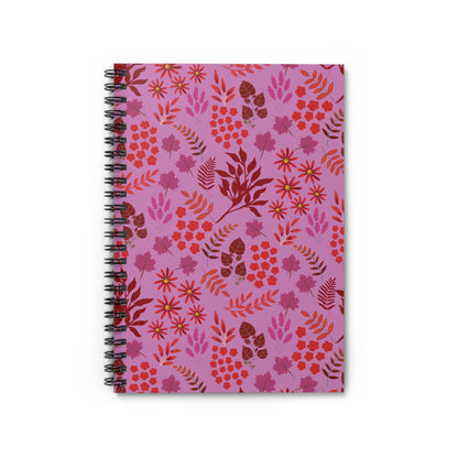 Floral Spiral Notebook with a pinkish-purple cover featuring a vibrant botanical pattern of red, orange, and magenta elements. Durable metal spiral binding for easy page turns; compact, eco-friendly design. Ideal for creative expression.