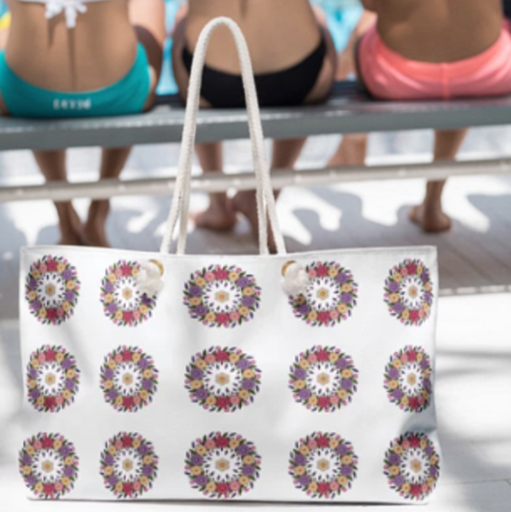 Crochet Floral Weekender Bag with intricate crochet floral patterns and sturdy white rope handles, showcasing FireBrook Designs' commitment to stylish, uplifting accessories for joyful travel experiences.