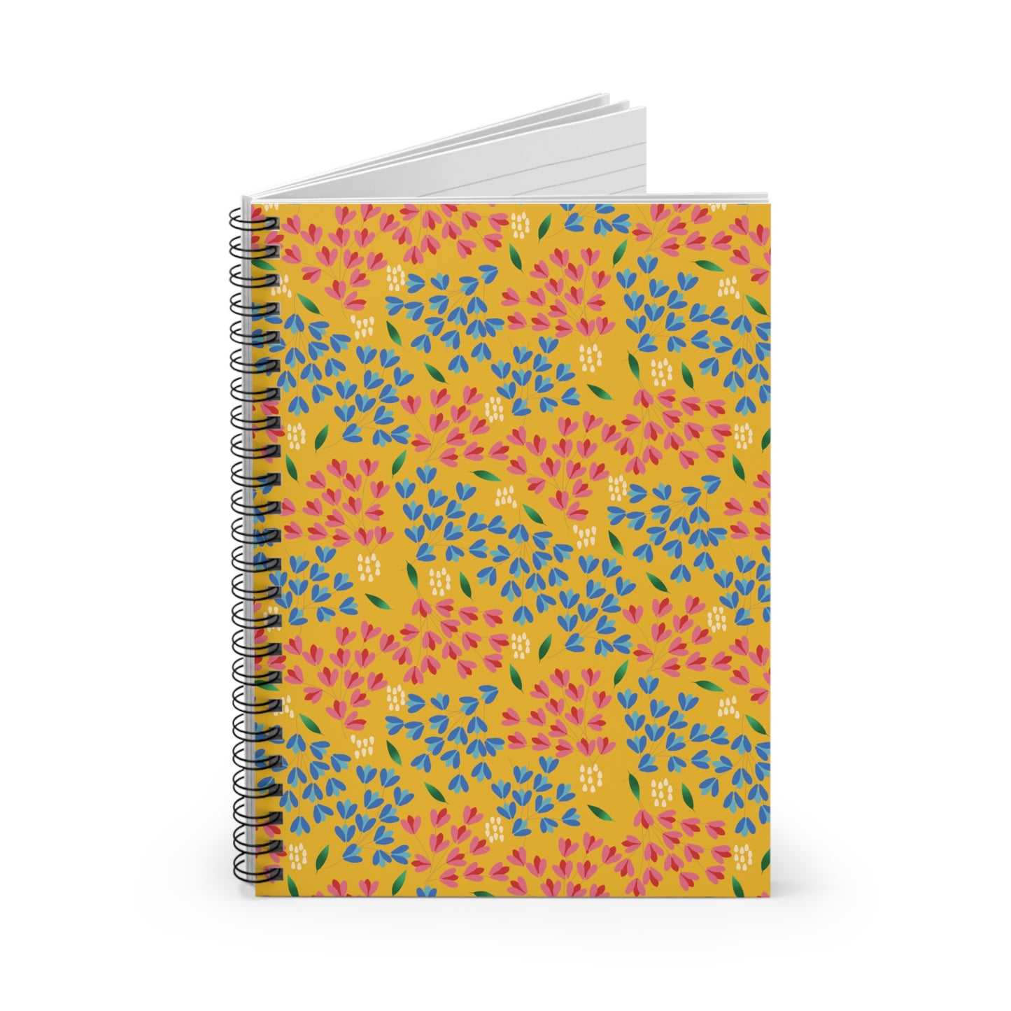 Floral Spiral Notebook with a vibrant mustard-yellow cover featuring a pink, blue, and green floral motif, standing upright. Its open pages reveal lined paper, perfect for creative note-taking or journaling.