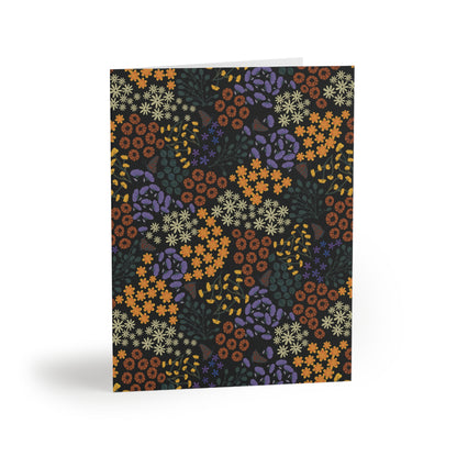 Floral Greeting Cards — Pack of 8/16/24, featuring a dense, vibrant floral pattern on a matte finish, stand elegantly folded, showcasing their blank white interior, ready to personalize with thoughtful messages.