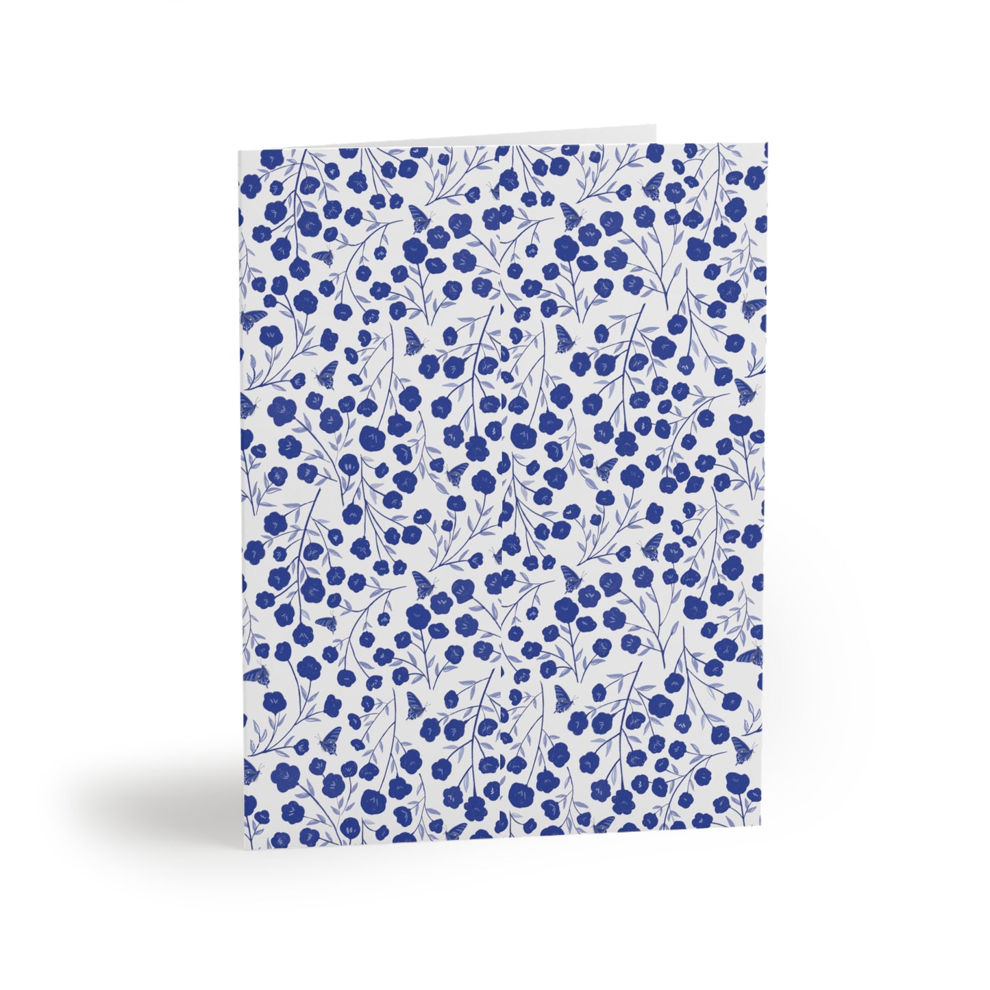 Floral Greeting Cards — Pack of 8/16/24 feature a blue floral pattern with tiny blossoms and butterflies on a white matte-finish cover, ideal for heartfelt messages, complete with matching envelopes.
