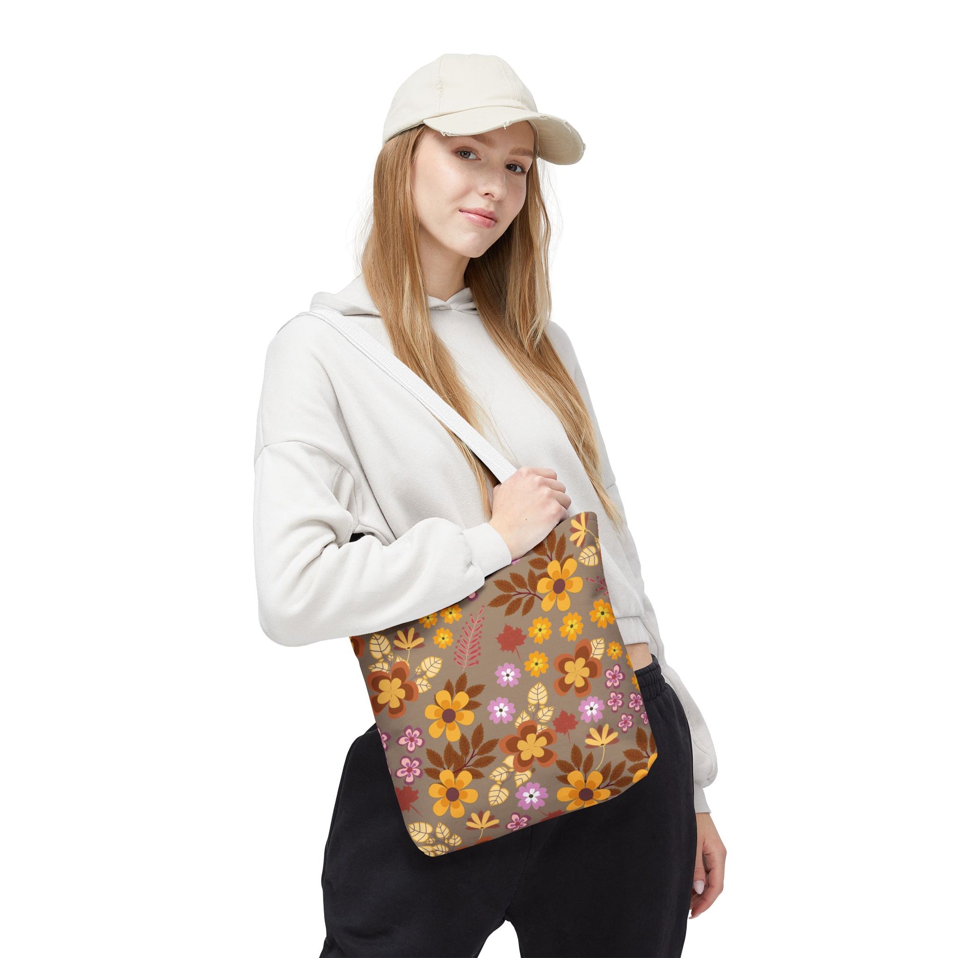 Person carrying the Harvest Brown Bloom Tote Bag with all-over floral pattern, showcasing stylish and durable design. The bag complements their casual outfit, perfect for summer outings or market trips.