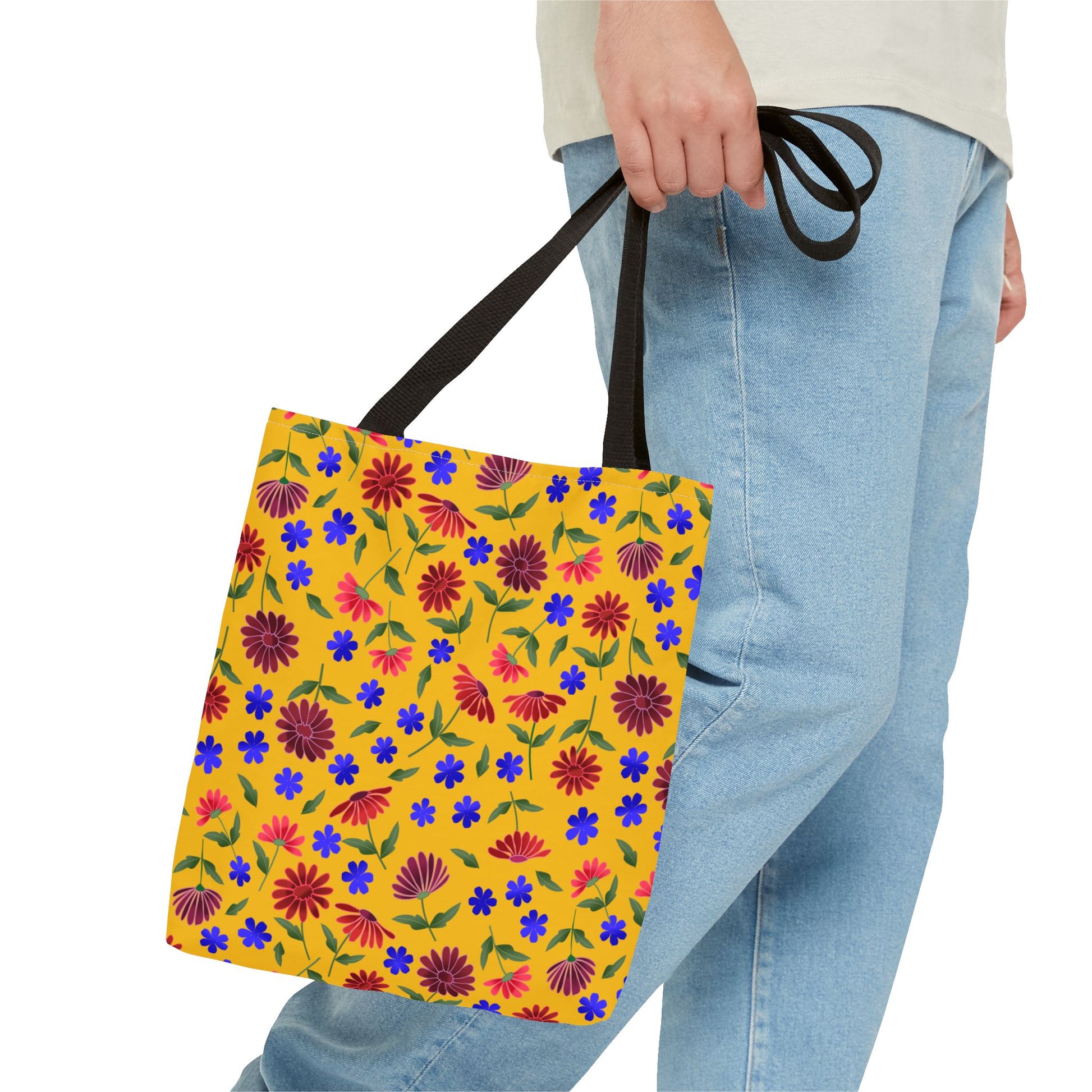 Golden Wildflower Tote Bag featuring a vivid yellow canvas with red and purple floral patterns, held by black straps. Perfect for versatile everyday use, combining style and practicality effortlessly.