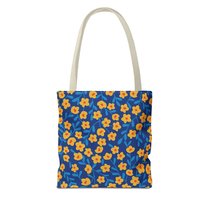 Floral Tote Bag featuring a vibrant pattern of small yellow flowers with orange centers on a deep blue backdrop. With light-beige handles, it's ideal for summer outings and cheerful style enthusiasts.