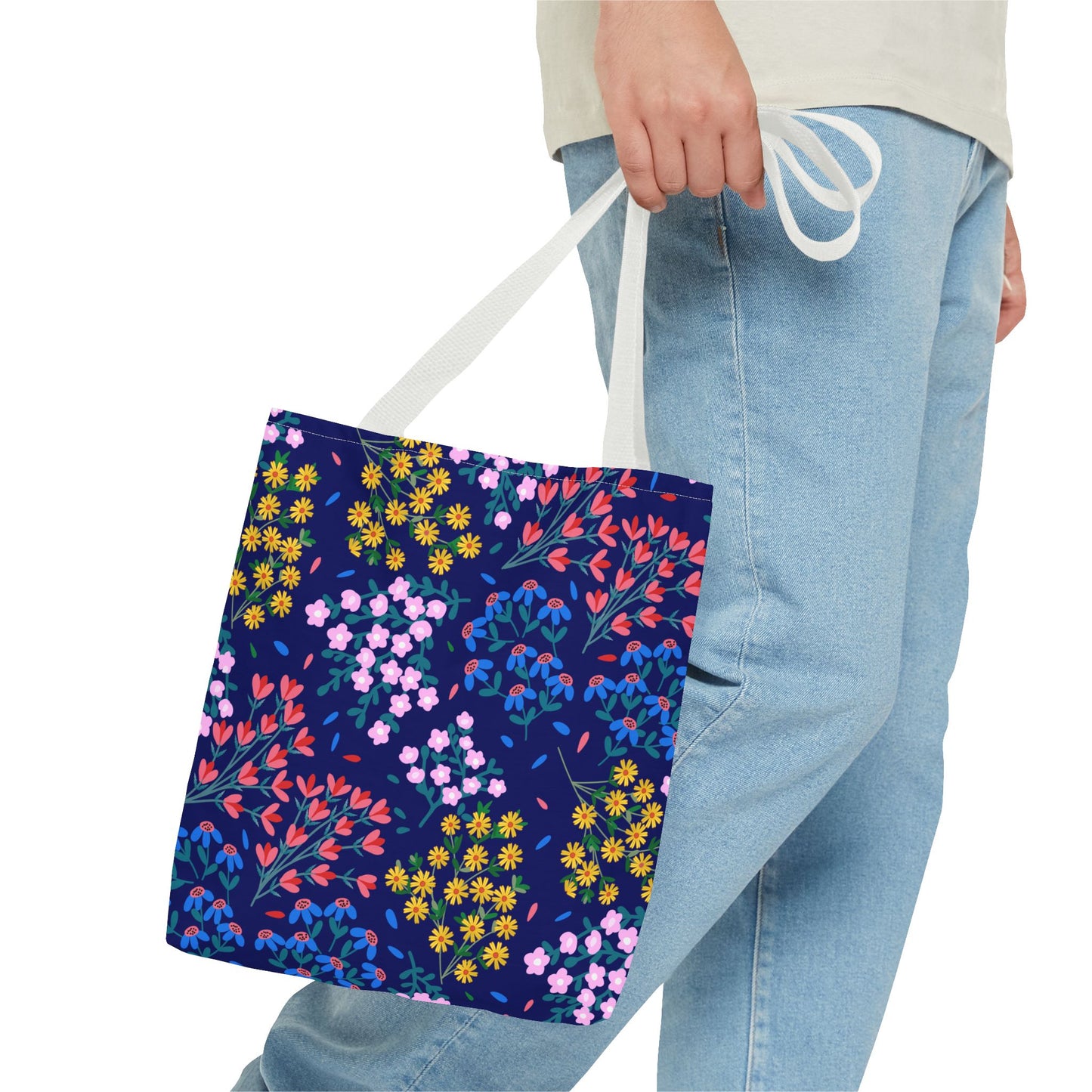 Floral Night Garden Tote in hand, showcasing a vibrant, hand-drawn floral pattern against a navy backdrop. Lightweight with reinforced handles, it's perfect for colorful, durable everyday use.