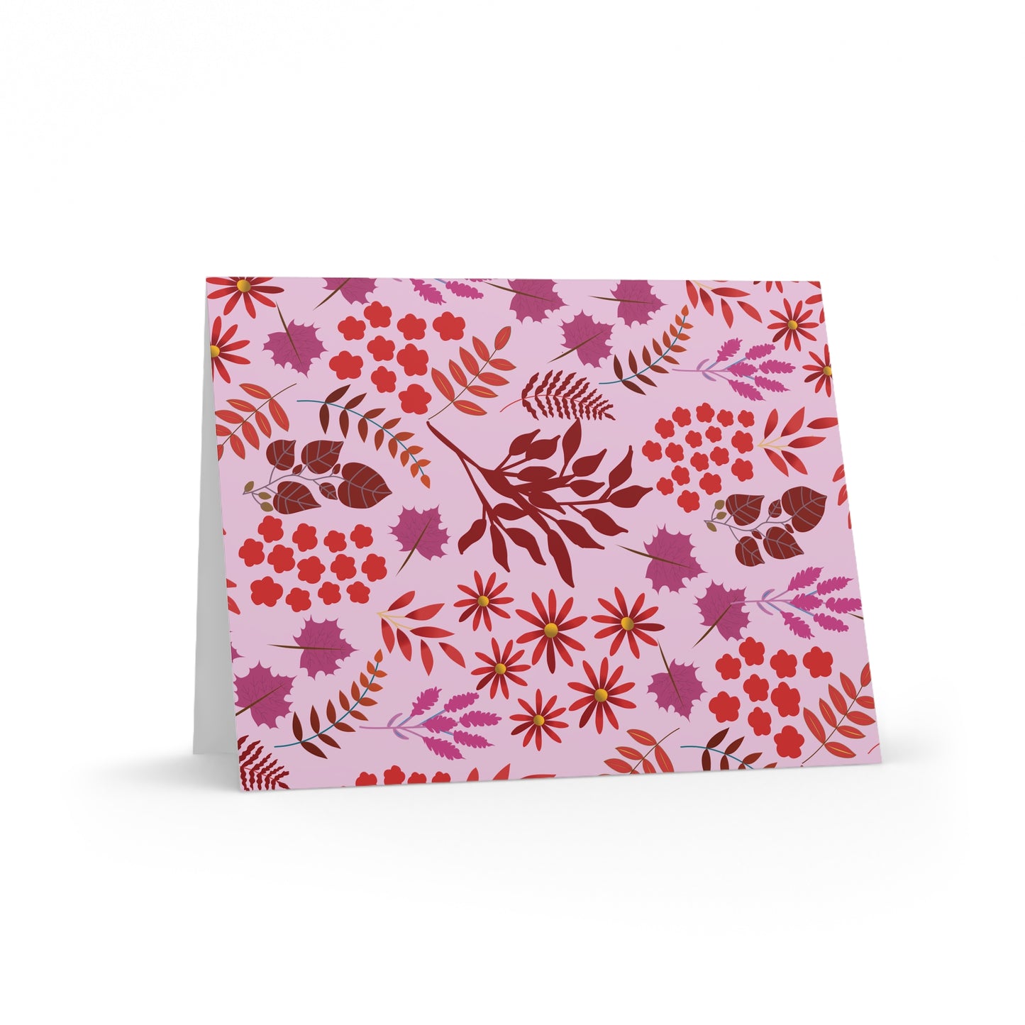 Greeting Cards — Pack of 8/16/24, featuring a floral-and-foliage pattern in reds, pinks, and purples on a light pink background, displayed open at a slight angle, showcasing FireBrook Essentials' uplifting design.
