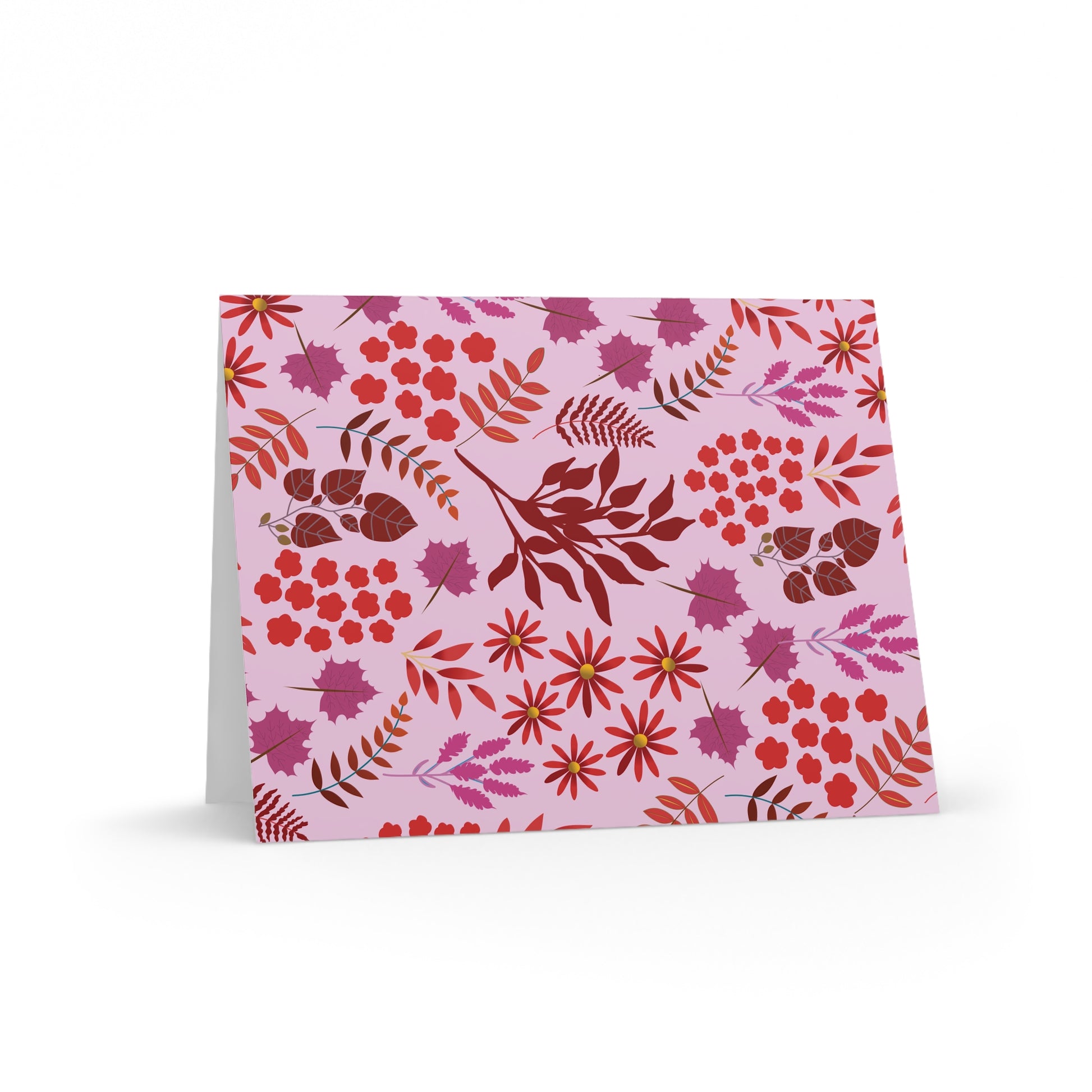 Greeting Cards — Pack of 8/16/24, featuring a floral-and-foliage pattern in reds, pinks, and purples on a light pink background, displayed open at a slight angle, showcasing FireBrook Essentials' uplifting design.