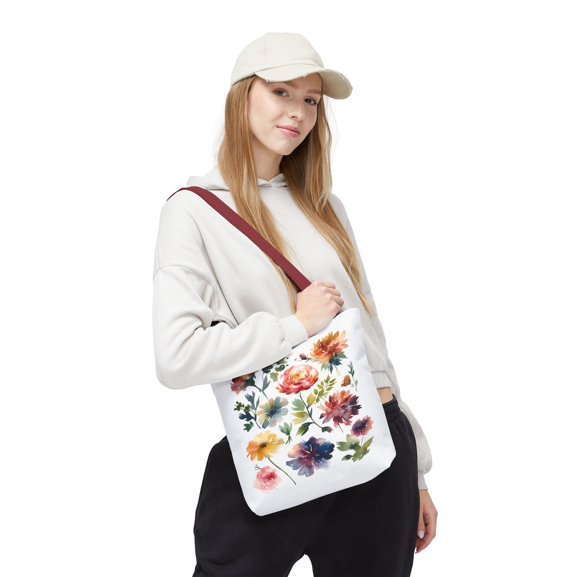 Woman in hat holding Watercolor Floral Tote Bag, showcasing its stylish, durable design ideal for daily use. Perfect for adding charm to errands or adventures.