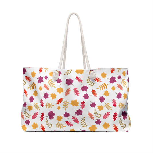 Weekender Bag with rope handles features a vibrant autumn-leaf pattern on white, ideal for stylish travel. Designed by FireBrook Essentials, it combines functionality and joy in a spacious, chic tote.