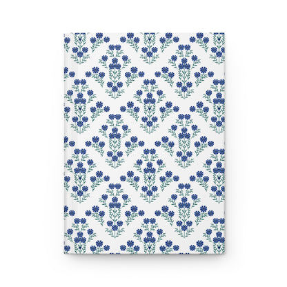 HARDCOVER JOURNAL, MATTE, RULED, 5X7, SEWN BIND, CLEAN-TEAR PAGES – INDIGO DAISY: White cover adorned with blue floral motifs in chevron pattern, offering elegance and functionality with 150 lined, easily removable pages.