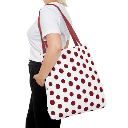 Woman holds Burgundy Polka Dots Tote Bag, showcasing its stylish and functional design. The durable polyester tote is ideal for everyday use, offering reinforced handles and boxed corners for extra room.