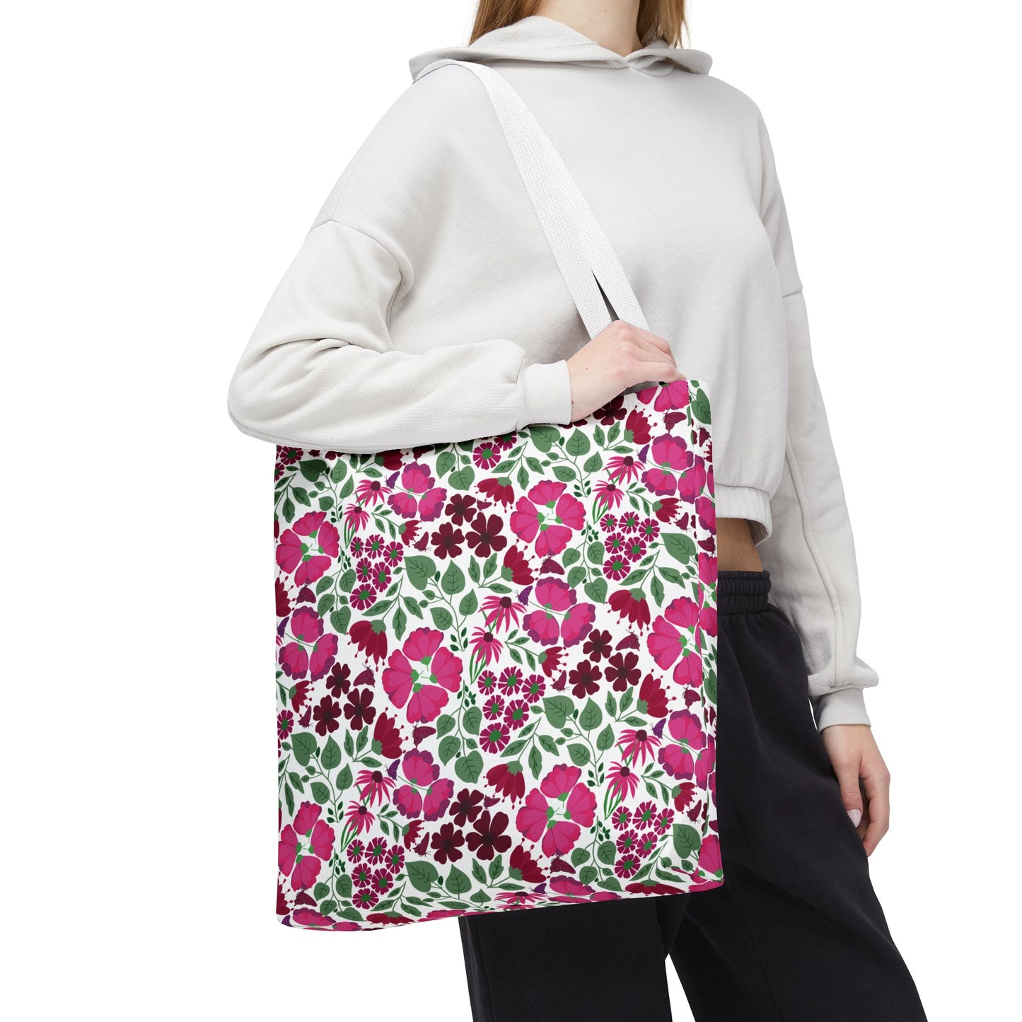 The Pink Lady Tote Bag showcases a vibrant pink and berry floral print, perfect for adding a pop of color to everyday outfits. Ideal for errands or beach trips, embodying FireBrook Designs' cheerful style.