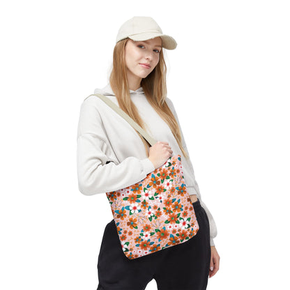 Floral Tote Bag featuring a peach-tone background with orange and white blooms, held by a casually dressed young person. Ideal for summer outings, reflecting FireBrook Essentials' joyful and stylish design ethos.