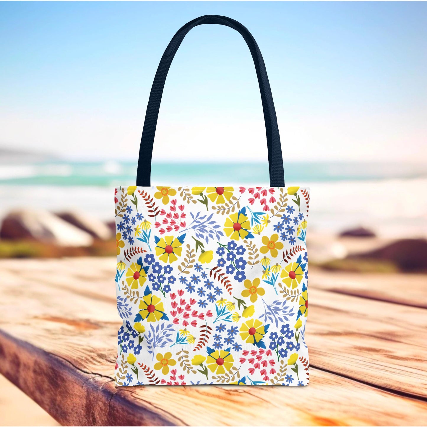 Floral Tote Bag with black handles, featuring a vibrant floral pattern, perfect for summer outings. Its design reflects FireBrook Essentials' commitment to stylish and uplifting products that bring joy to everyday life.