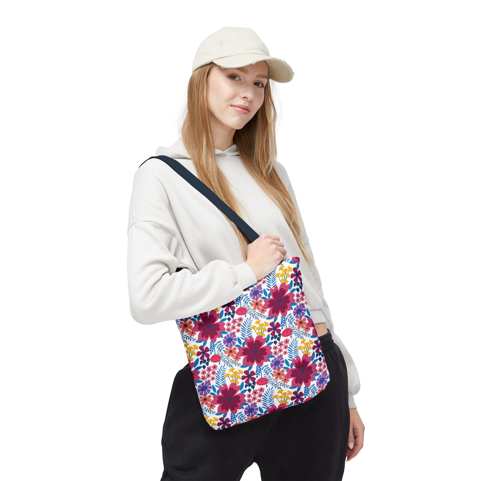 Young woman models the Violet Daisy Carnival Tote Bag, featuring a vibrant floral design, perfect for brightening summer outings. The bag is slung over her shoulder, showcasing its casual, cheerful style.