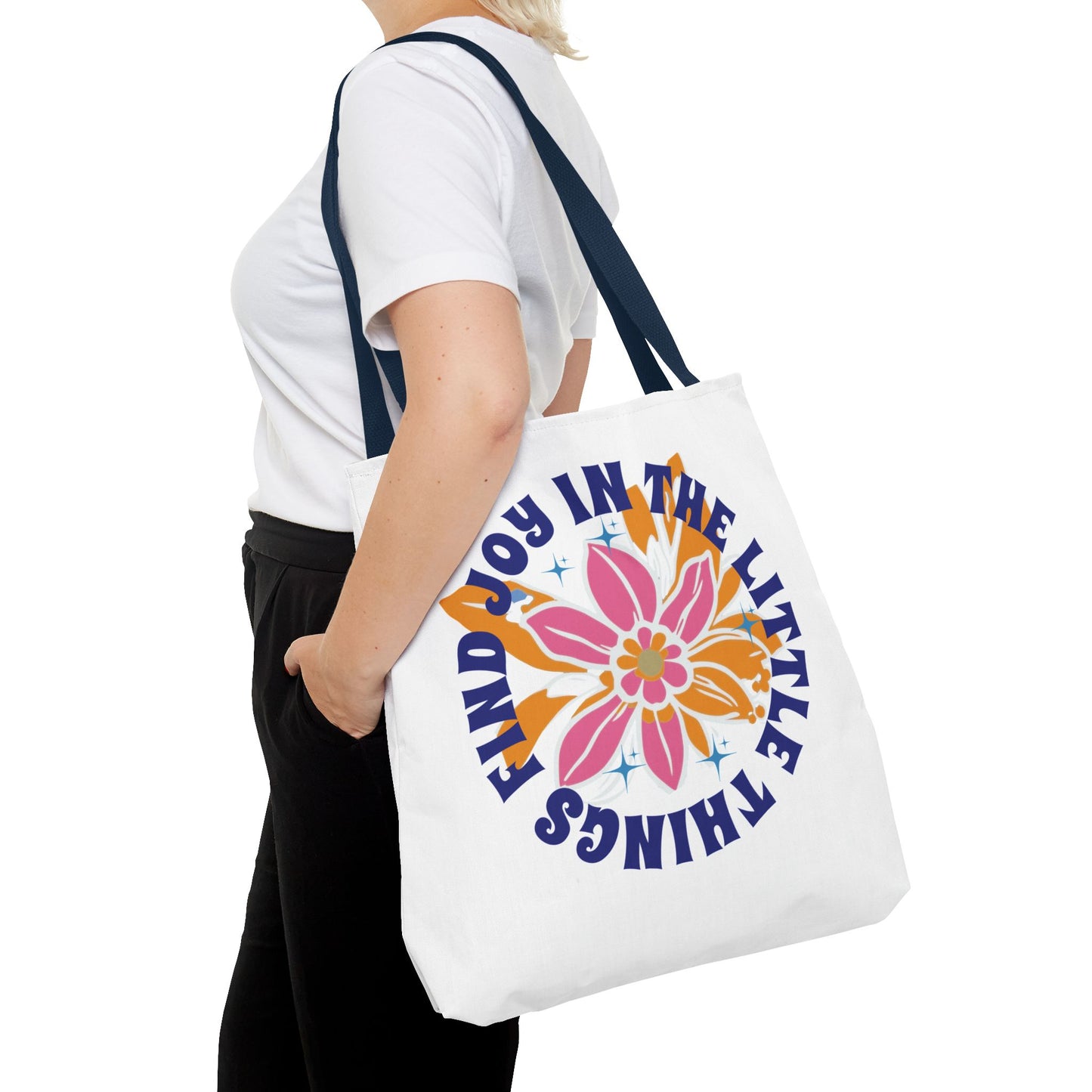 Find Joy in Little Things Tote Bag held by woman, showcasing a colorful flower design, perfect for spreading positivity and carrying essentials.