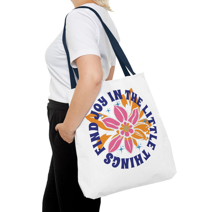 Find Joy in Little Things Tote Bag held by woman, showcasing a colorful flower design, perfect for spreading positivity and carrying essentials.